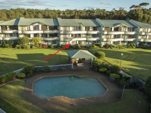 an aerial view of a large apartment building with a swimming pool at Fathoms 2 in Mollymook