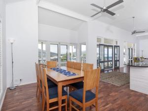 a kitchen and dining room with a table and chairs at Surf Break Unit 10B Tuna Cresent Upstairs in Fingal Bay