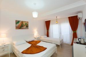 Postel nebo postele na pokoji v ubytování Ayka Hotel