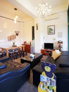 a living room with a couch and a dining room at Green Window Homestay in Hualien City