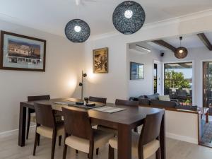 a dining room with a table and chairs at Ocean Views in Mollymook