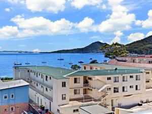 a view of the water and buildings at The Shoal, Unit 510/4-8 Bullecourt Street in Shoal Bay