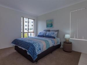 a bedroom with a bed and a window at Tradewinds Unit 3 110 Victoria Parade in Nelson Bay