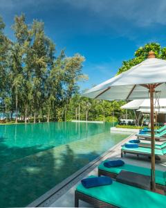 a swimming pool with umbrellas on top of it at Dusit Thani Krabi Beach Resort - SHA Extra Plus in Klong Muang Beach