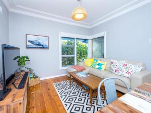a living room with a couch and a table at Victor Parade 5 in Shoal Bay