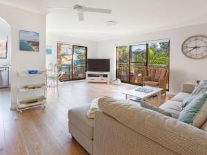 a living room with a couch and a tv at Victory Court Unit 1 3 7 Columbia Close in Nelson Bay