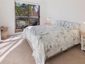 a bedroom with a bed and a window at Victory Court Unit 1 3 7 Columbia Close in Nelson Bay