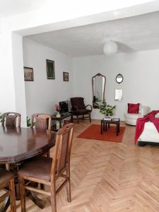 a living room with a table and chairs and a couch at Sunshine house in Pančevo