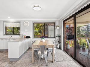 a kitchen and dining room with a table and chairs at Wahgunyah Road 50 in Nelson Bay