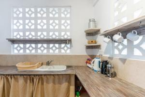 A kitchen or kitchenette at Tequila Sunrise Forest Cabana - on Diani Beach