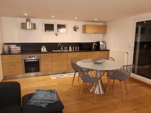 uma cozinha com mesa e cadeiras num quarto em Très bel appartement avec vue sur les montagnes em Saint-Ismier