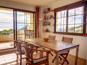 a dining room with a wooden table and chairs at Casa Altea Hills, Vista panorámica, Jacuzzi in Altea