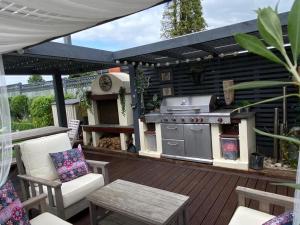 a patio with a grill and a table and chairs at Winsor Croft in Southampton