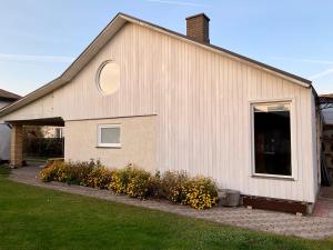 a house with a circle window on the side of it at Two story tiny house in Ventspils
