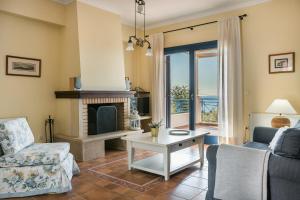 a living room with a couch and a fireplace at Villa Rudi in Trapezaki +16 photos