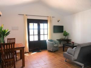 a living room with a door and a table and chairs at Finca Felix Appartement met Private Pool! in Lajares