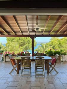 a patio with a table and chairs under awning at Beach House With Direct Access to Private Beach Near Bodrum in Çamlık