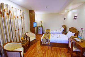 Postel nebo postele na pokoji v ubytování Royal Pearl Hotel