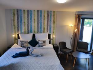 a bedroom with a bed with a towel on it at Pension zur Perle in Büsum