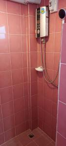 a bathroom with a pink tiled wall with a shower at A.N. HOUSE in Chiang Mai