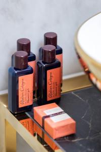 three bottles of essential oils sitting on a shelf at Kazimierz Studio with Jacuzzi by Renters Prestige in Kraków