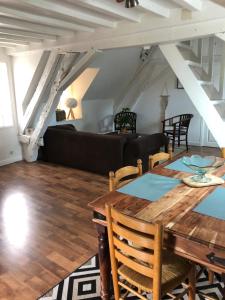 a living room with a table and a couch at Le Grand Appartement - 90m2- 2 chb , 1 mezzanine - 6pers in Romorantin