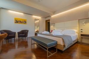 Le Cappuccinelle Suites&SPA tesisinde bir odada yatak veya yataklar