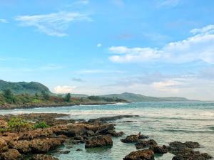 a view of a beach with rocks and the ocean at 南灣陽光皮小妞 Pii hostel in Nanwan