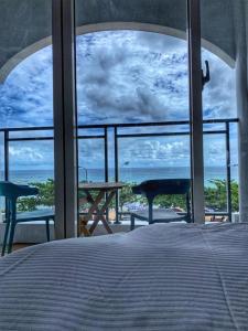 a bedroom with a bed and a view of the ocean at 南灣陽光皮小妞 Pii hostel in Nanwan