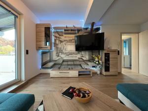 a living room with a tv on a wall at Ferienwohnung Familie Büchel in Zella-Mehlis