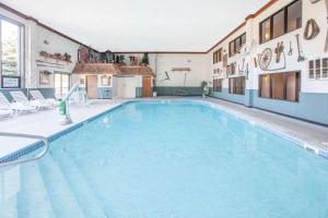 a large swimming pool in the middle of a building at Super 8 by Wyndham Houghton Lake in Houghton Lake