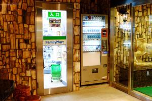 a familymart machine with a green cart in a store at Hotel Check In Shimbashi in Tokyo