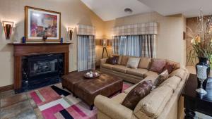 a living room with a couch and a fireplace at Best Western Lapeer Inn in Lapeer