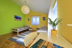 a room with green walls and a table and chairs at Vanda Land penthouse in Zadar