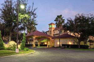 a hotel with a building with a clock tower at La Quinta by Wyndham Houston West Park 10 in Houston