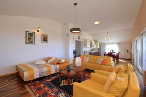 a living room with couches and a couch and a table at Vanda Land penthouse in Zadar