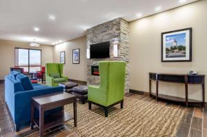 sala de estar con chimenea y TV en Comfort Inn & Suites Salina North, en Salina
