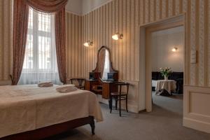 a hotel room with a bed and a mirror at Hotel Praga 1885 in Prague