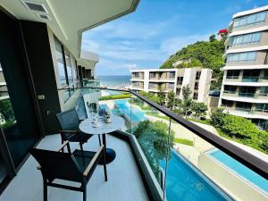 a balcony with a table and a view of the ocean at Veranda Residence Hua-Hin in Hua Hin