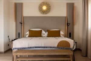 a bedroom with a large bed with a wooden headboard at Hotel L'Acquale in Calvi