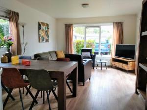 a living room with a table and a couch at Holiday rentals in Velsen-Zuid