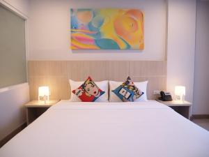 Postel nebo postele na pokoji v ubytování Malee Hotel