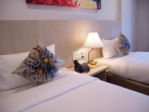 Postel nebo postele na pokoji v ubytování Malee Hotel