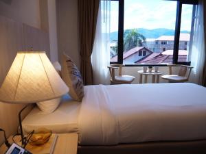 Postel nebo postele na pokoji v ubytování Malee Hotel