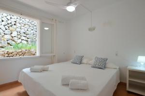 a bedroom with a large white bed and a window at Alconasser 2 - Amazing Seaviews between Deia & Soller in Sóller