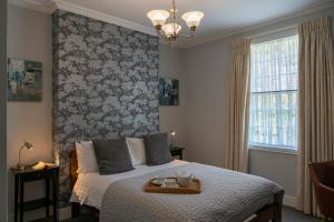 A bed or beds in a room at Queensberry House B&B