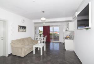 a living room with a couch and a table at Villa Antea Apartments with Free Parking in Dubrovnik