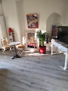 a living room with a white piano and chairs at Maison de caractère face à l abbaye de lagrasse in Lagrasse