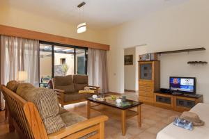 salon z kanapą i telewizorem w obiekcie La Casa del Sol l by Best Holidays Fuerteventura w Corralejo