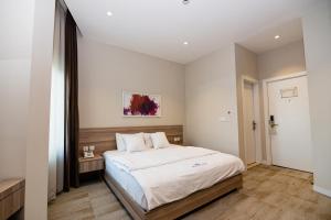 a bedroom with a large bed in a room at Niagara Hotel Erbil in Erbil